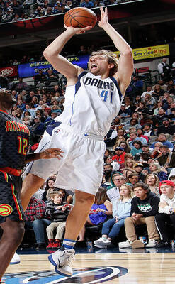 Photo of Dirk Nowitzki in action on the court, jumping about to shoot the ball