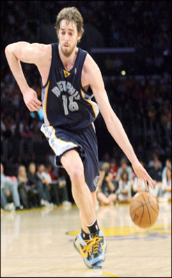 Photo of Pau Gasol in action on the court, running while dribbling ball on left hand